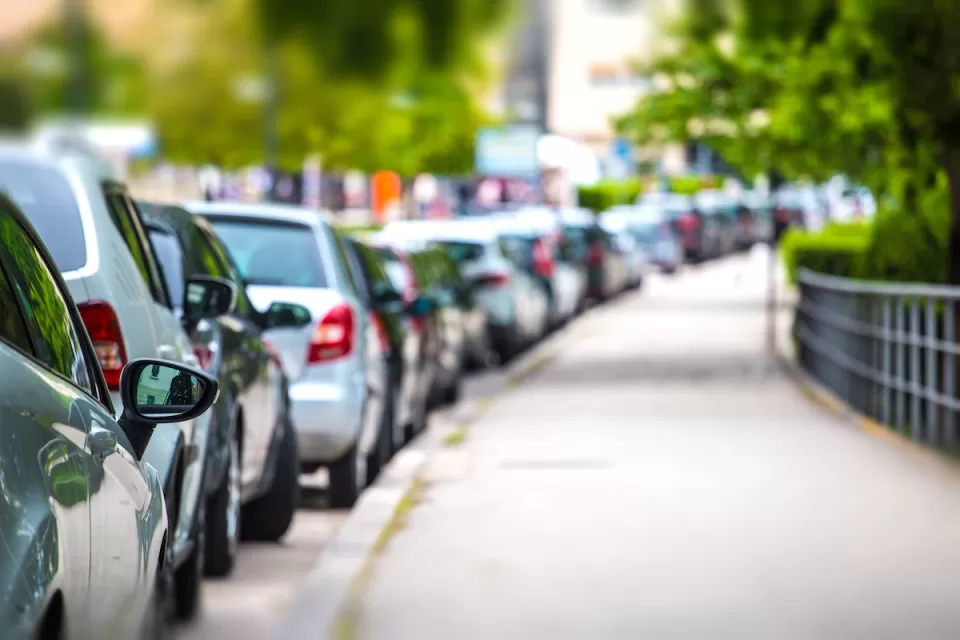 Row of parked cars along curb.